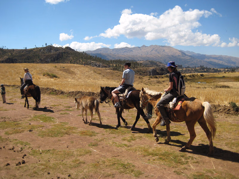Luxury Peru Tours - People riding on horseback through the Sacred Valley in Peru