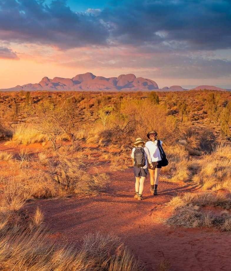 The red desert landscapes of Uluru–Kata Tjuta National Park, and the sweeping curve of white sand at Wineglass Bay in Freycinet National Park.