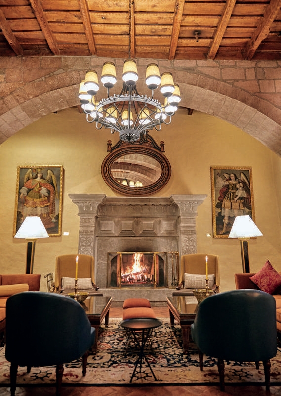 Hotel lounge with fireplace at Belmond Hotel Monasterio, Peru