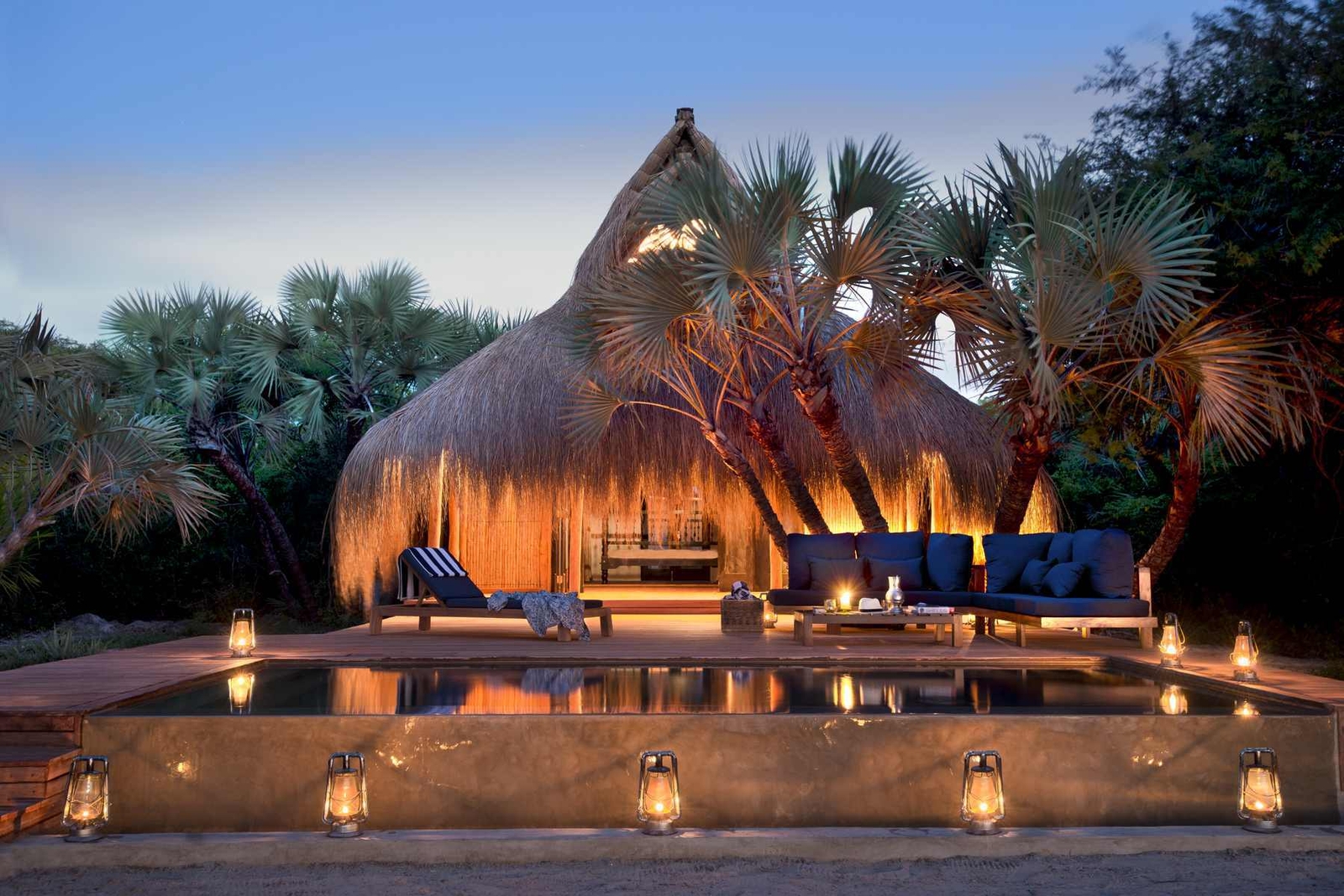 An external view of a casita or villa of andBeyond Benguerra Island at sunset.