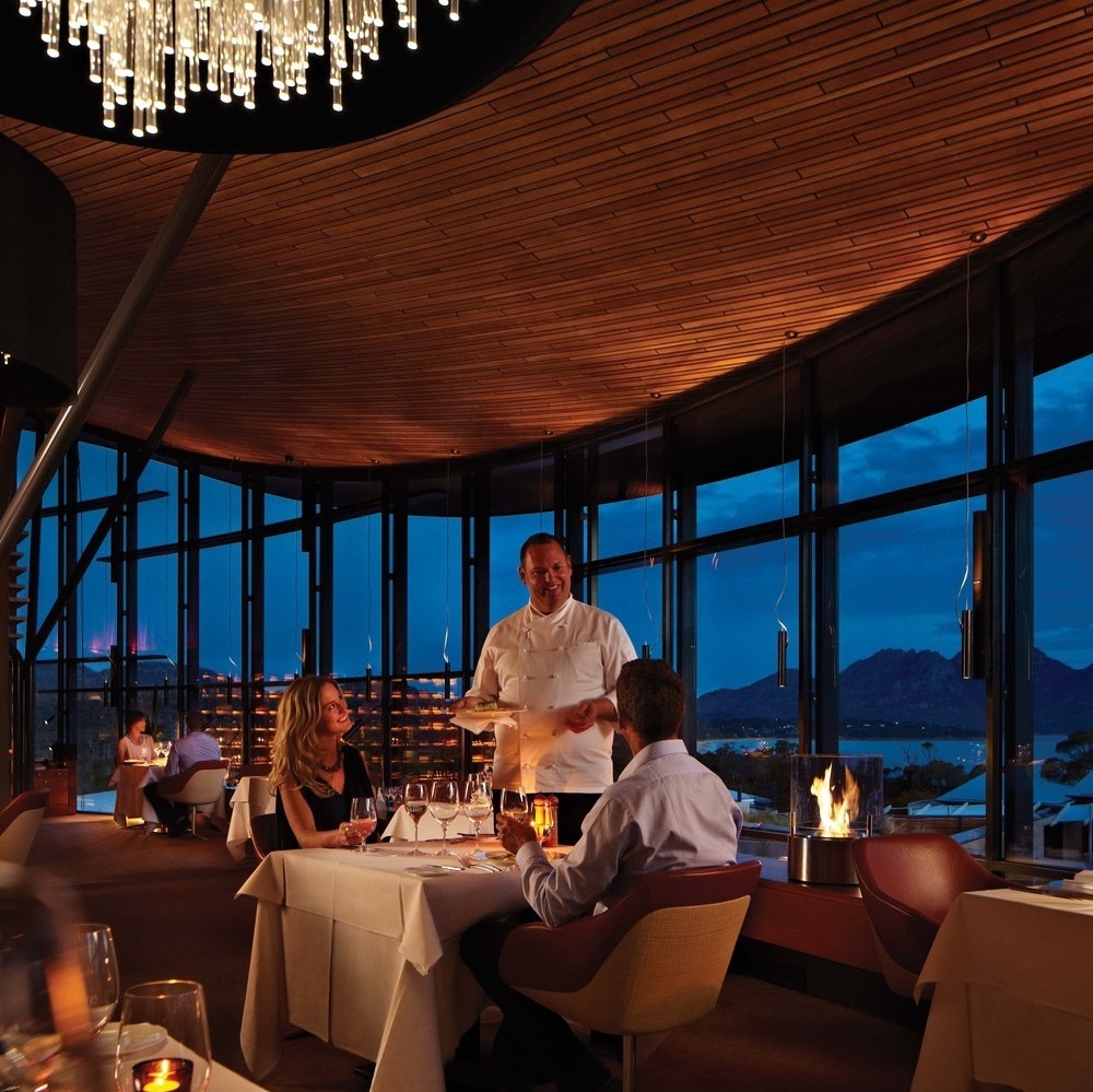 A couple dining in the restaurant during the evening at Saffire Freycinet