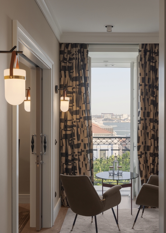 Two chairs facing a window in a bedroom at Bairro Alto hotel in Lisbon