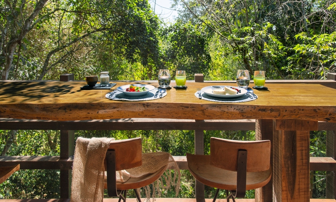 An open air dining area at Awasi Iguazu overlooking the forest.