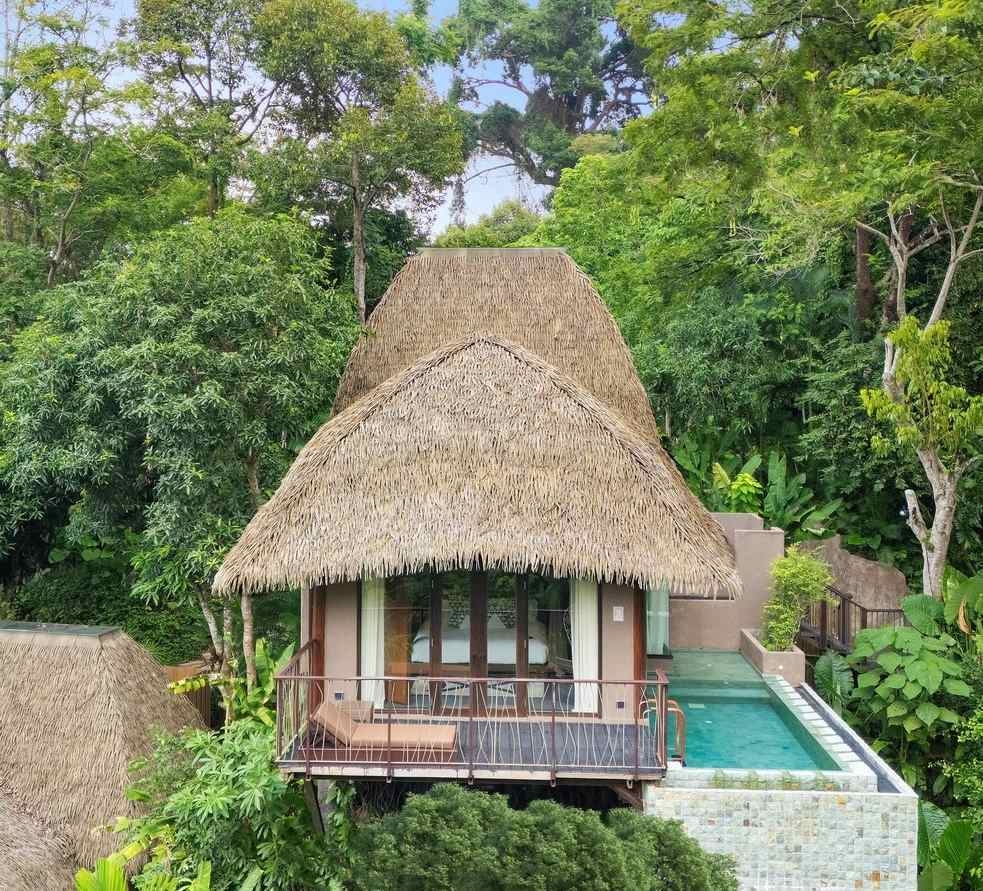 Keemala's clay pool cottage featuring a thatched roof, clay walls and a terrace with an infinity pool.