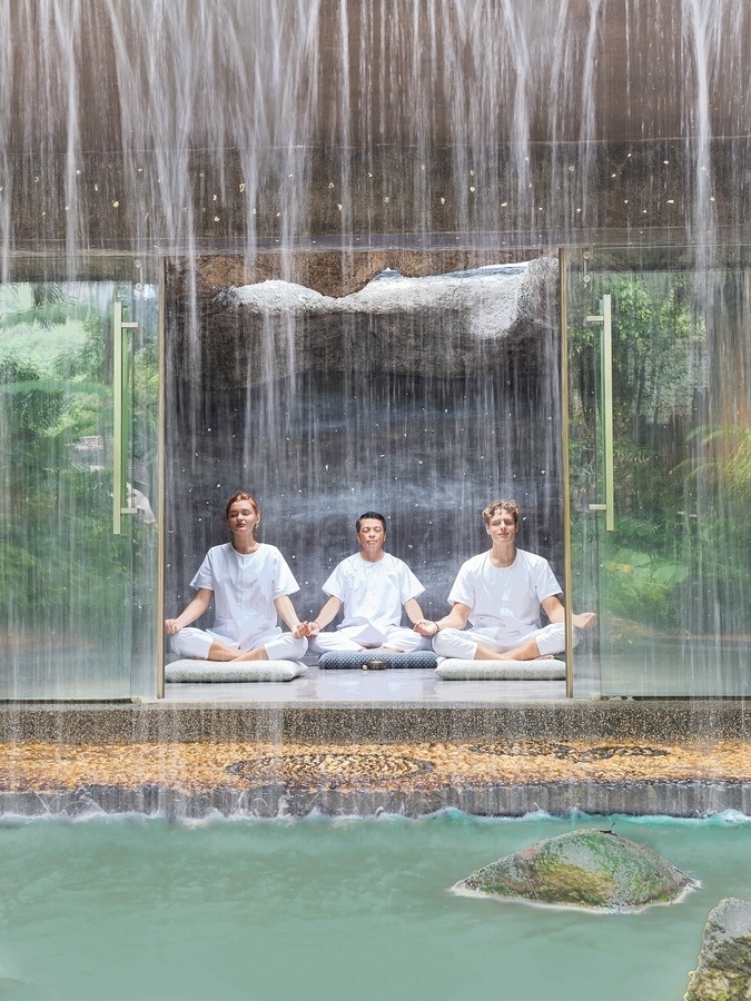 Three people meditating in Keemala's meditation cave.