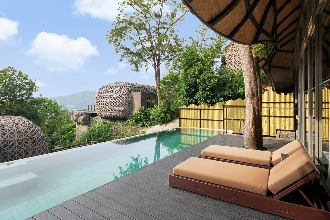 The pool area of Keemala's bird nest villa featuring a long infinity pool.