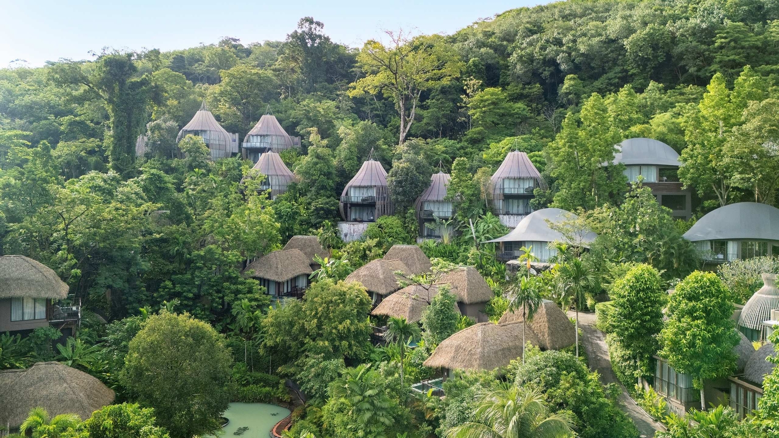 Keemala's villas as seen from afar spread out across a lush forest.