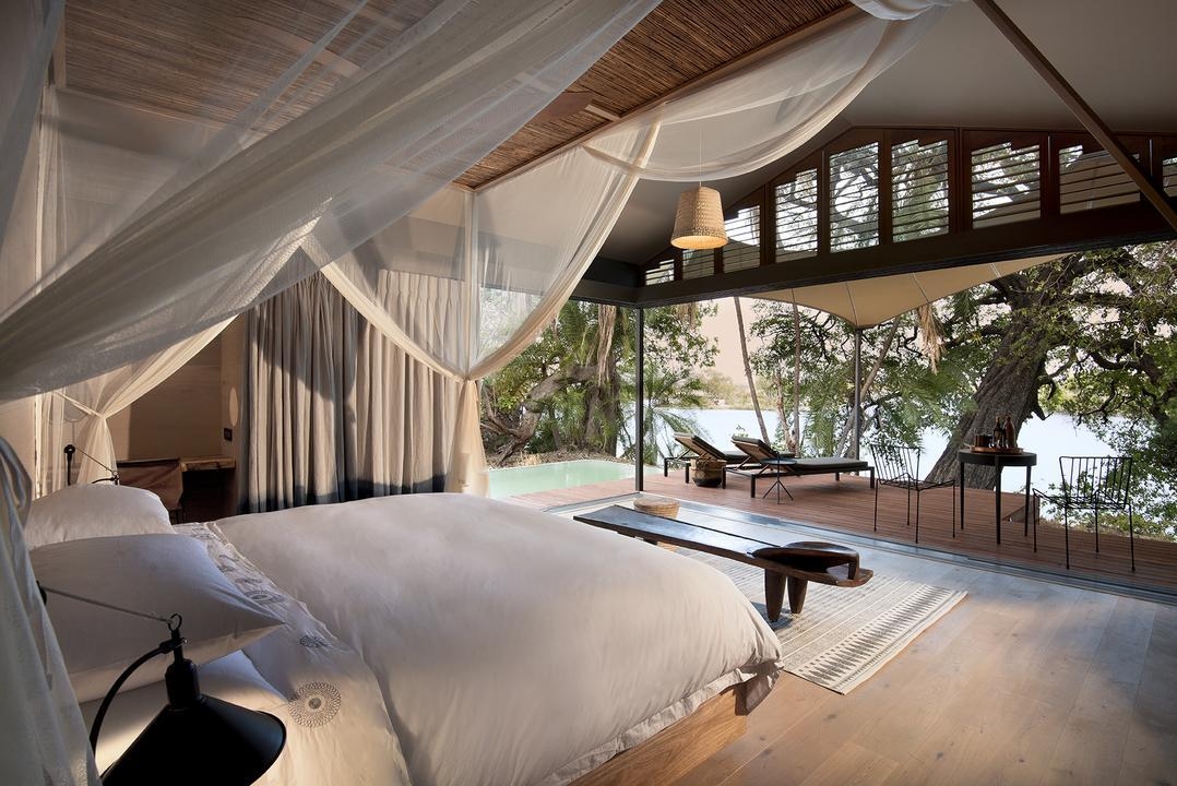 The bedroom of a suite at Thorntree River Lodge overlooking the Zambezi.