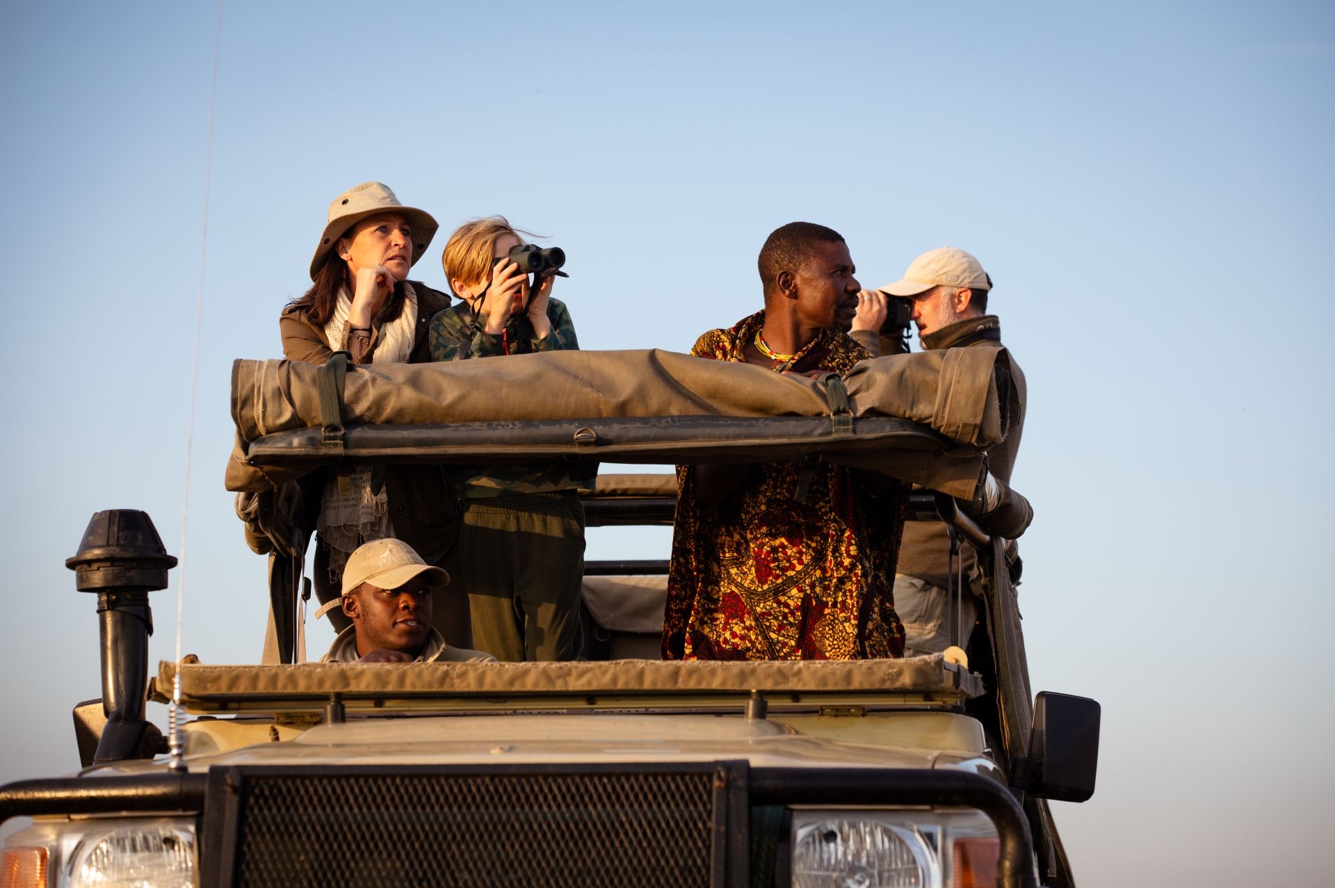 Game spotting from an open 4x4 safari vehicle in the Serengeti