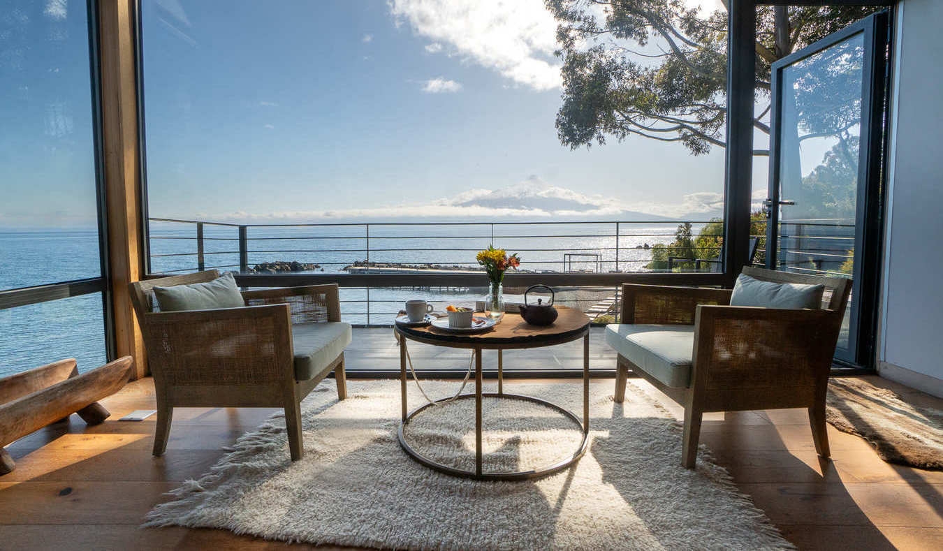 A private terrace of one of Hotel AWA's rooms overlooking the lake and volcano in the distance.