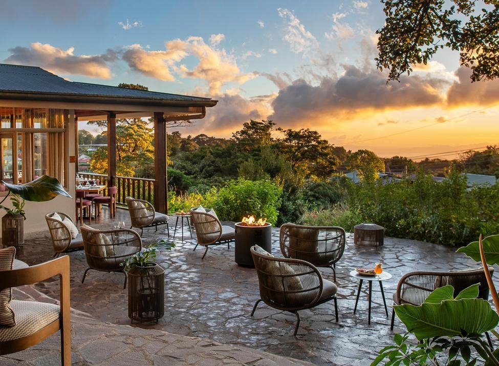 The outdoor lounge area at Senda Monteverde Hotel overlooking lush greenery.
