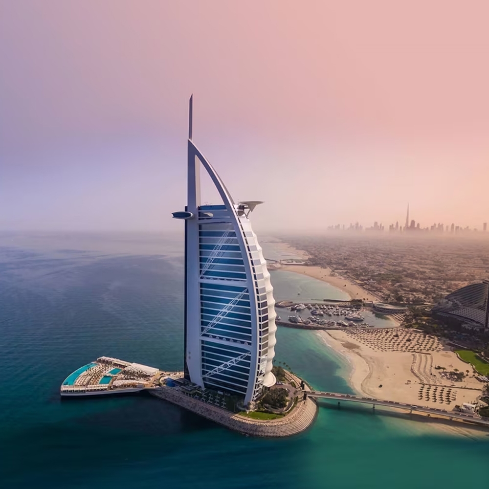 Burj Al Arab hotel on the Dubai coast at sunset, a highlight of luxury United Arab Emirates holidays.