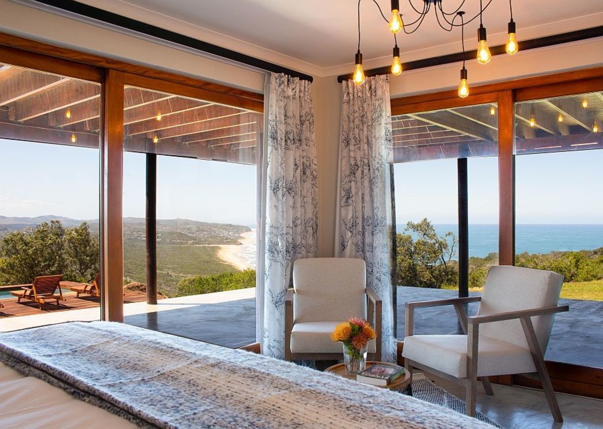 A bedroom with chairs at Simbavati Fynbos on Sea