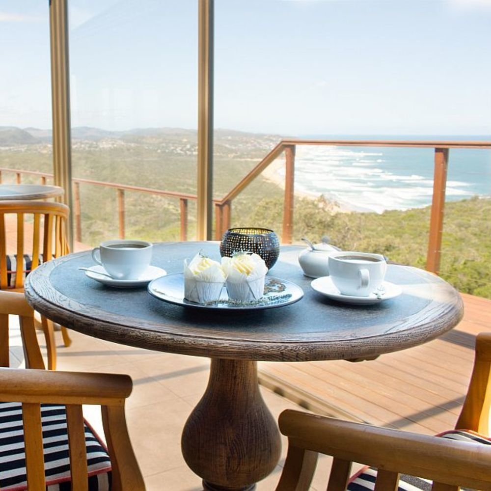 A breakfast table with a view of the sea at Simbavati Fynbos on Sea