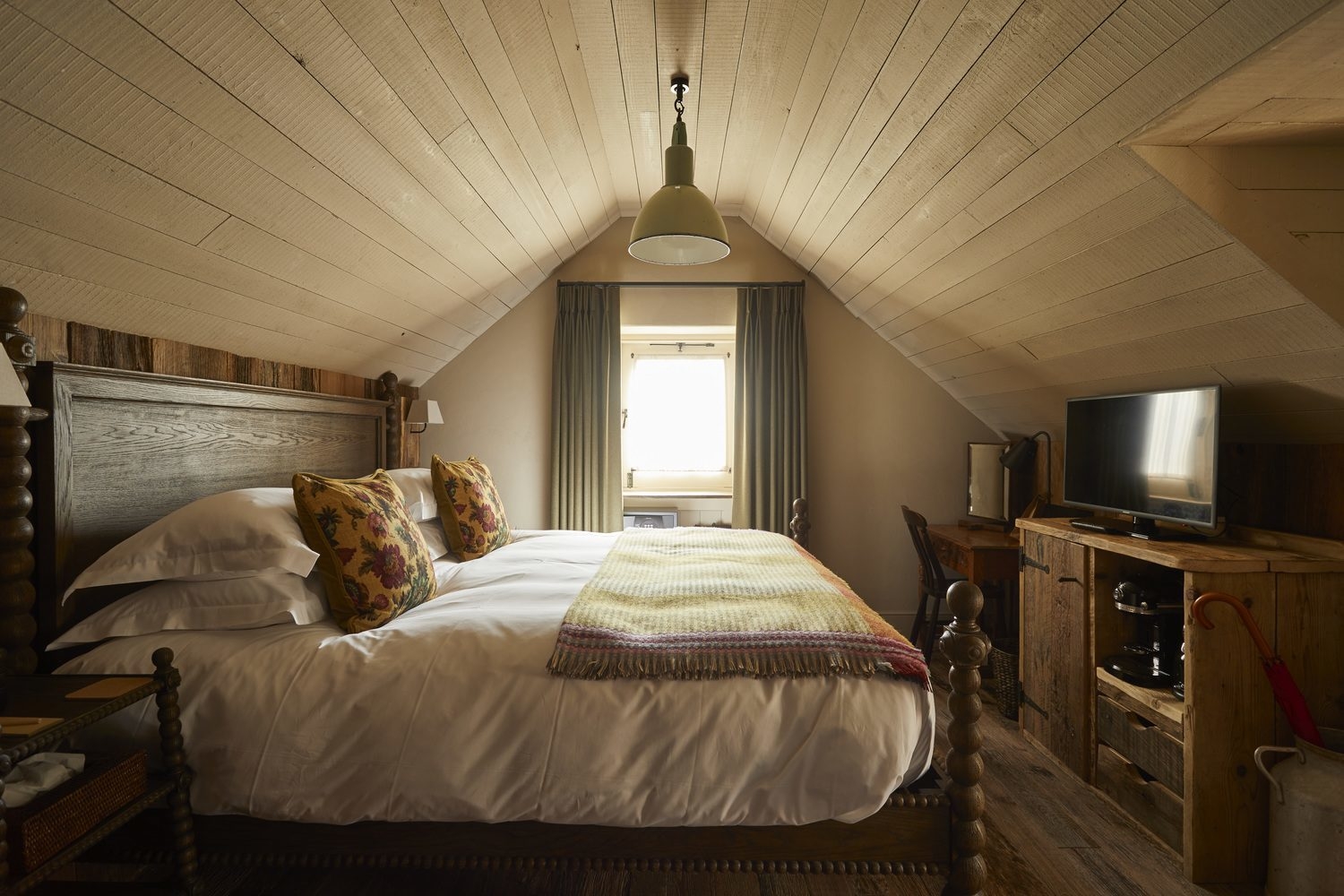 Attic room with sloping ceilings at The Pig at Harlyn Bay