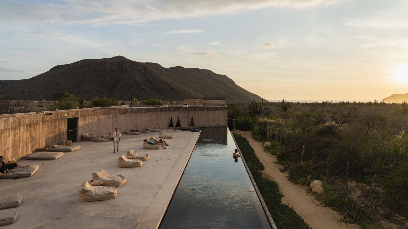 View of the outdoor pool with mountains in the background at Paradero in Todos Santos