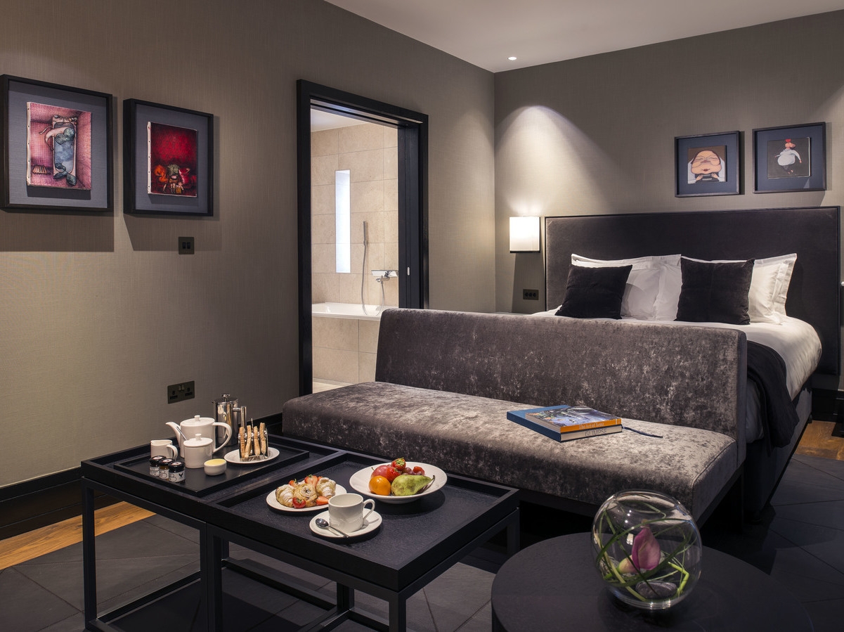 A bedroom with coffee table at Twr y Felin hotel