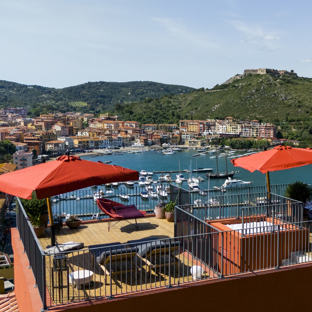 A rooftop terrace at La Roqqa overlooking the town of Porto Ercole.