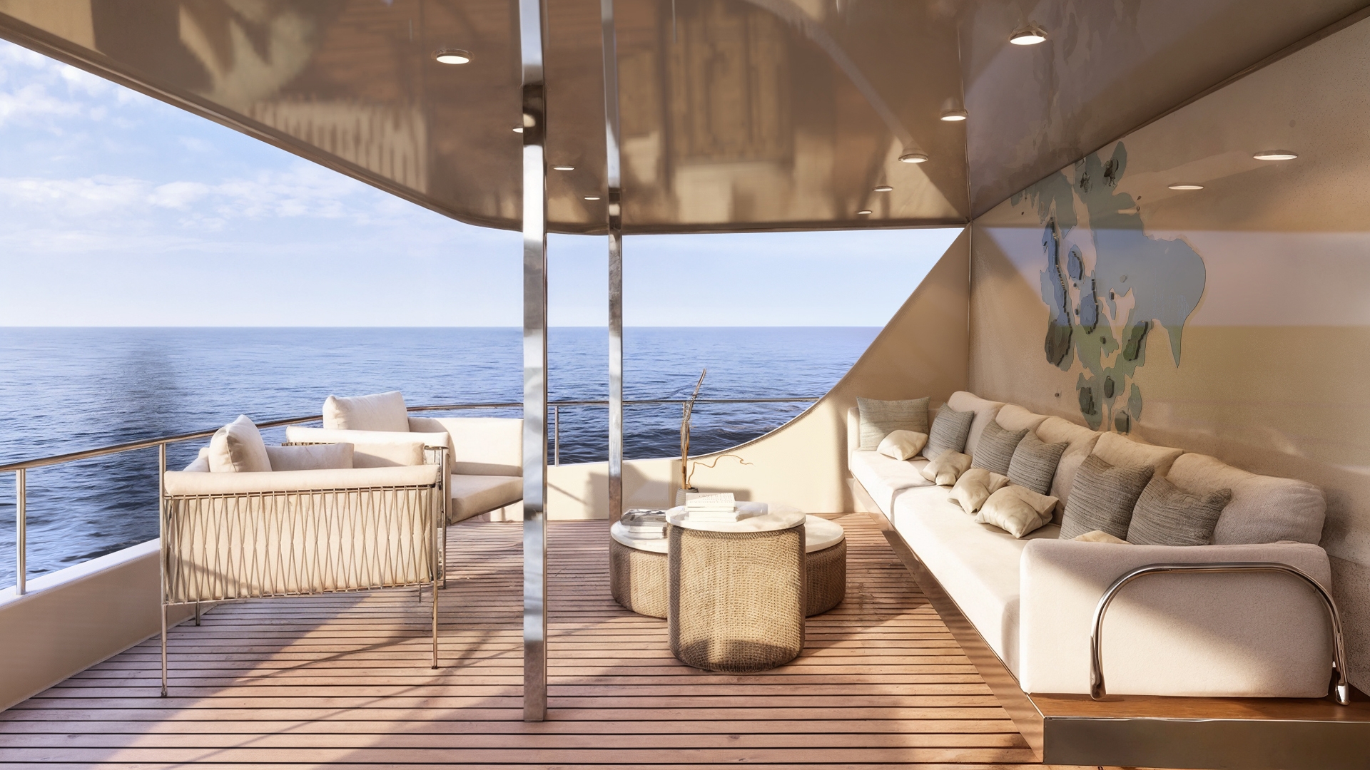 An open-air boat deck with a long sofa on the right with pillows and a low coffee table across from two white rattan chairs. The sun is shining onto the brown deck and furniture. In the background, a railing of the boat deck, and the sea, blue sky and white clouds.