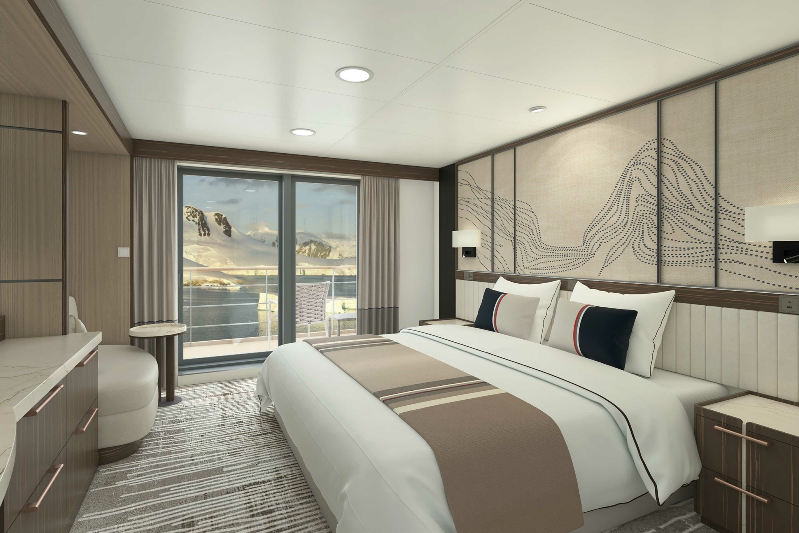 Bedroom with a bed with white and tan sheets and pillows, grey carpet and walls and a window overlooking water and mountains.