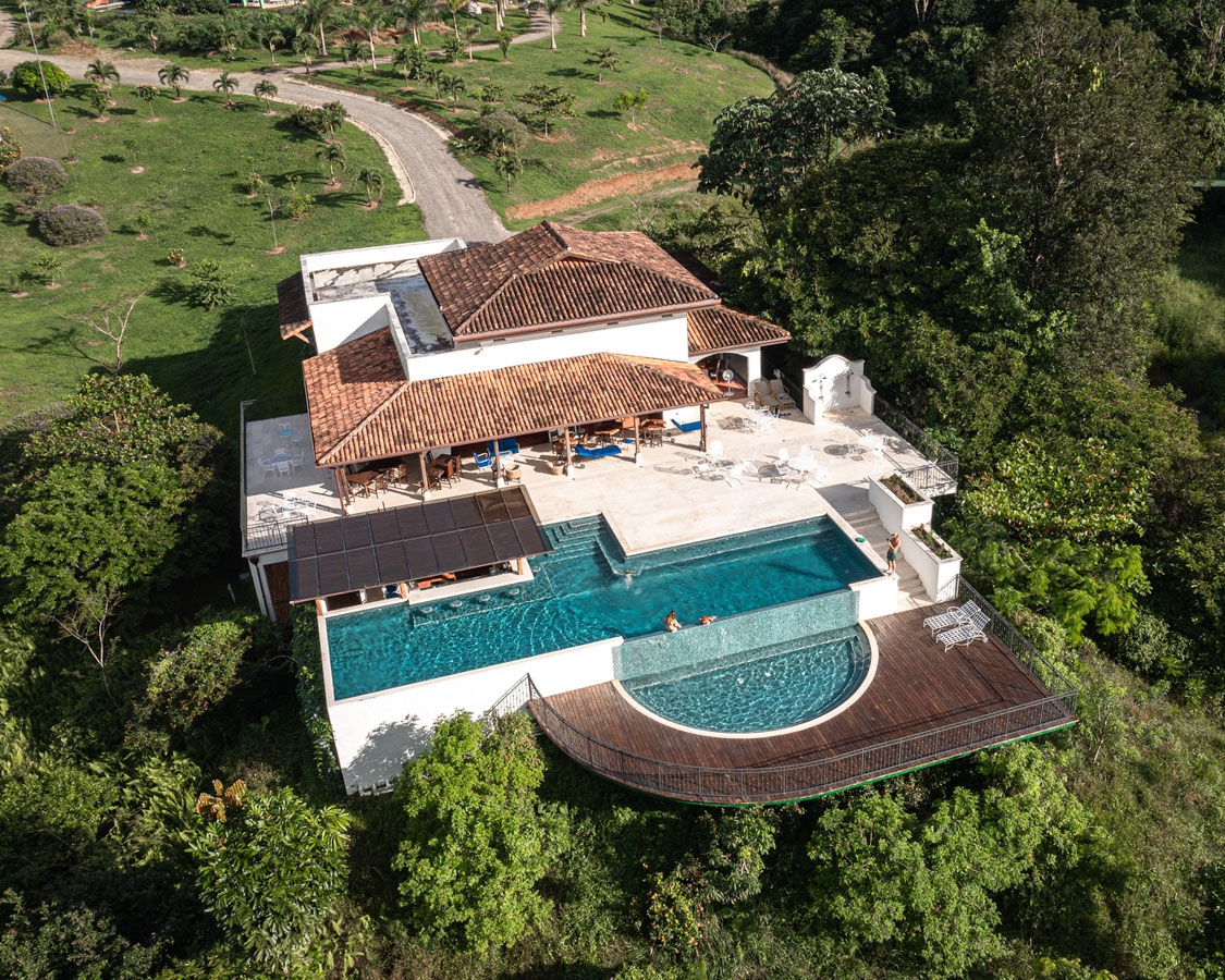 Aerial view of a lodge at El Lugar in Costa Rica with outside pool and veranda.