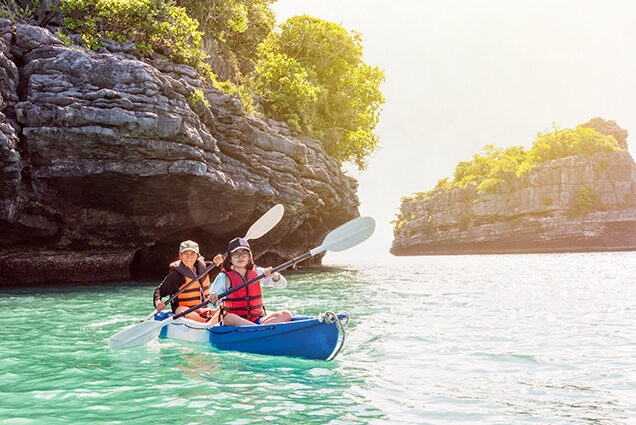 Luxury Thailand Tours - Mother and daughter travel by kayak in blue waters