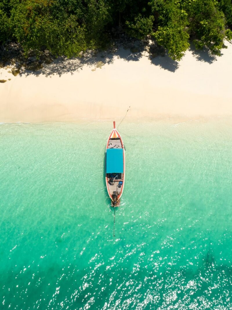 Luxury Thailand Tours - Long tail boat on the beach.Wonderful background.Aerial view from Andaman beach.