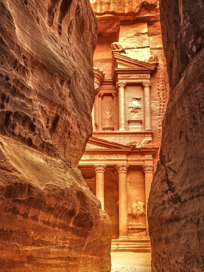 The Treasury at Petra seen through a narrow rock Siq during luxury grand tours and safaris.
