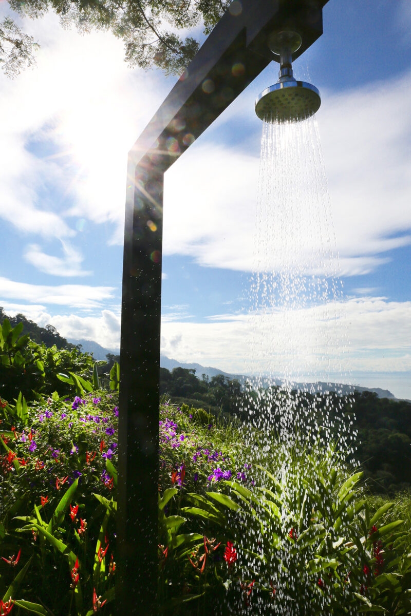 An outdoor shower amongst wildflowers in Costa Rica