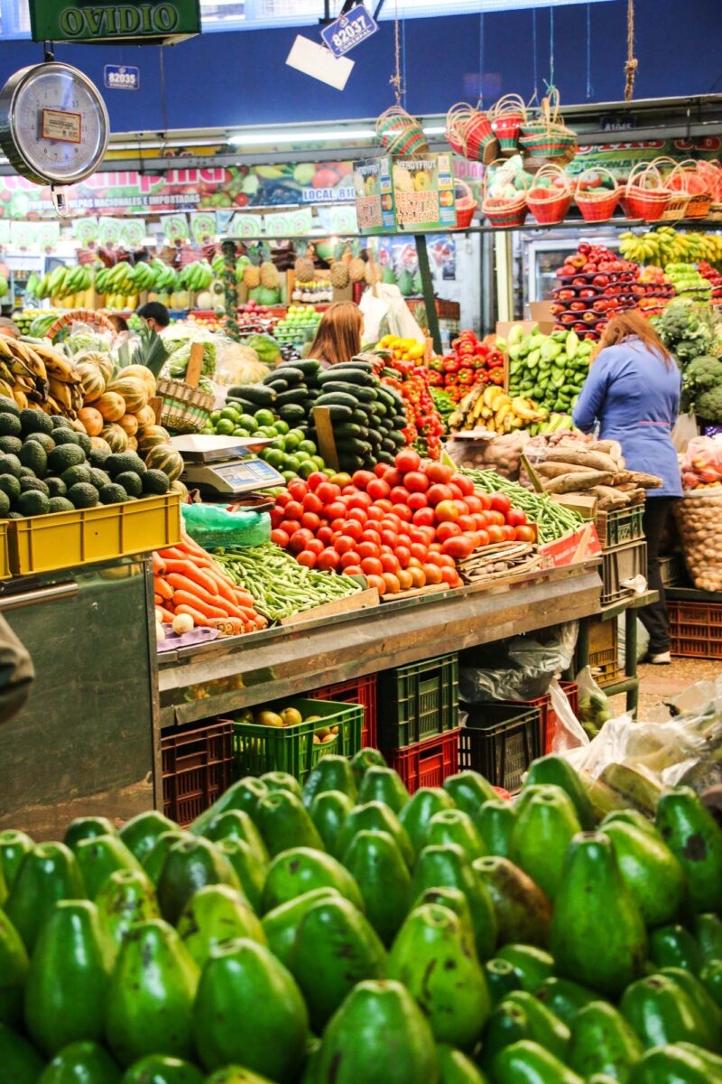 Fruit market in Colombia with trays piled high with colourful fruits and vegetables on luxury latin America tour