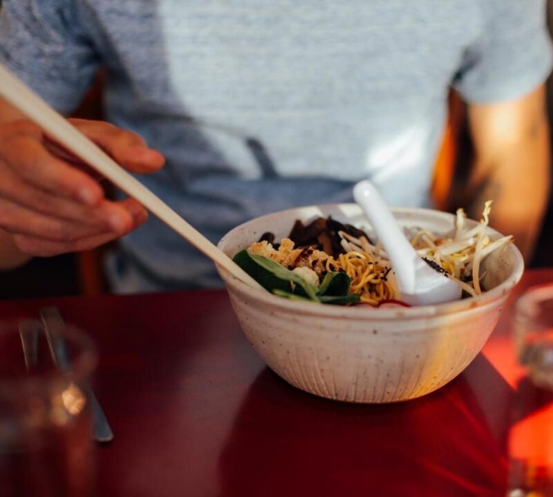 Soft focused shot of vegeterian vegan asian fusion dish, with authentic natural ingridients in fancy downtown cafe restaurant