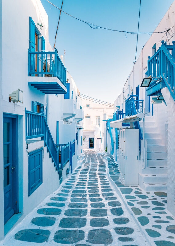 Cobbled streets with whitewashed buildings and blue doorways in Mykonos, Greece