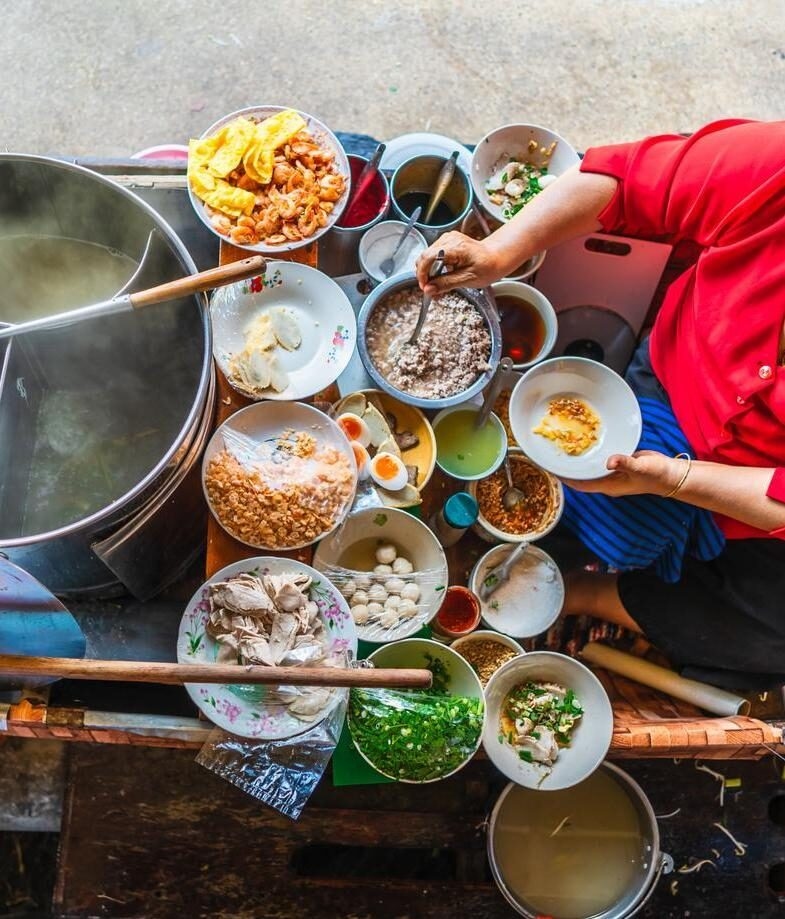 Aerial view of a woman selling streetfood in Vietnam