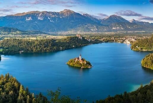 Refreshing summer hikes on Mount Etna in Sicily, the turquoise cove of Polignano a Mare in Puglia, and the island church on Lake Bled in Slovenia.
