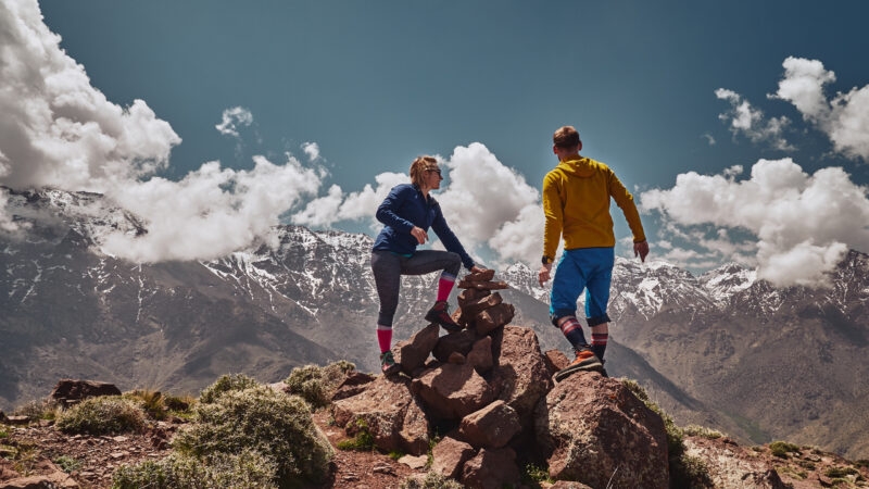 Young couple on a hike watch Toubkal massif