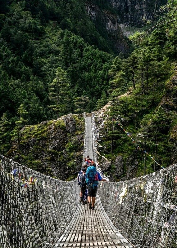 hiking family experience in Nepal crossing one of its hanging bridges