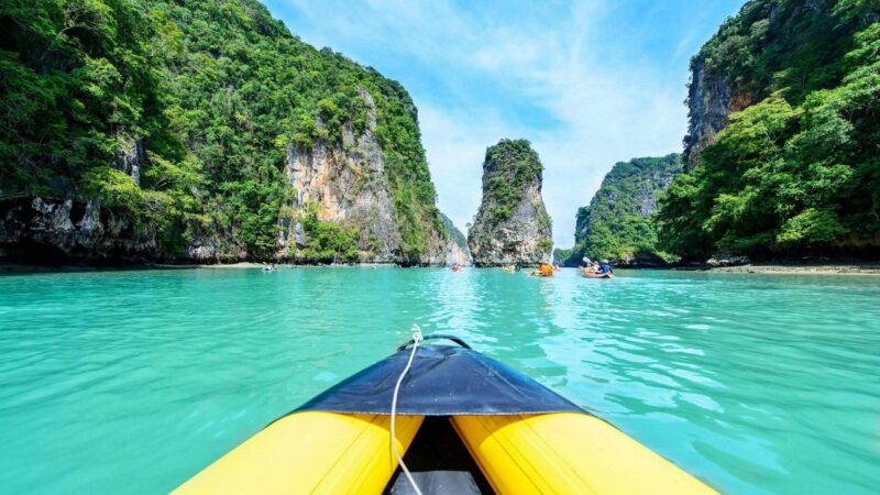 Kayaking among limestone karsts in Phang Nga bay, Thailand.