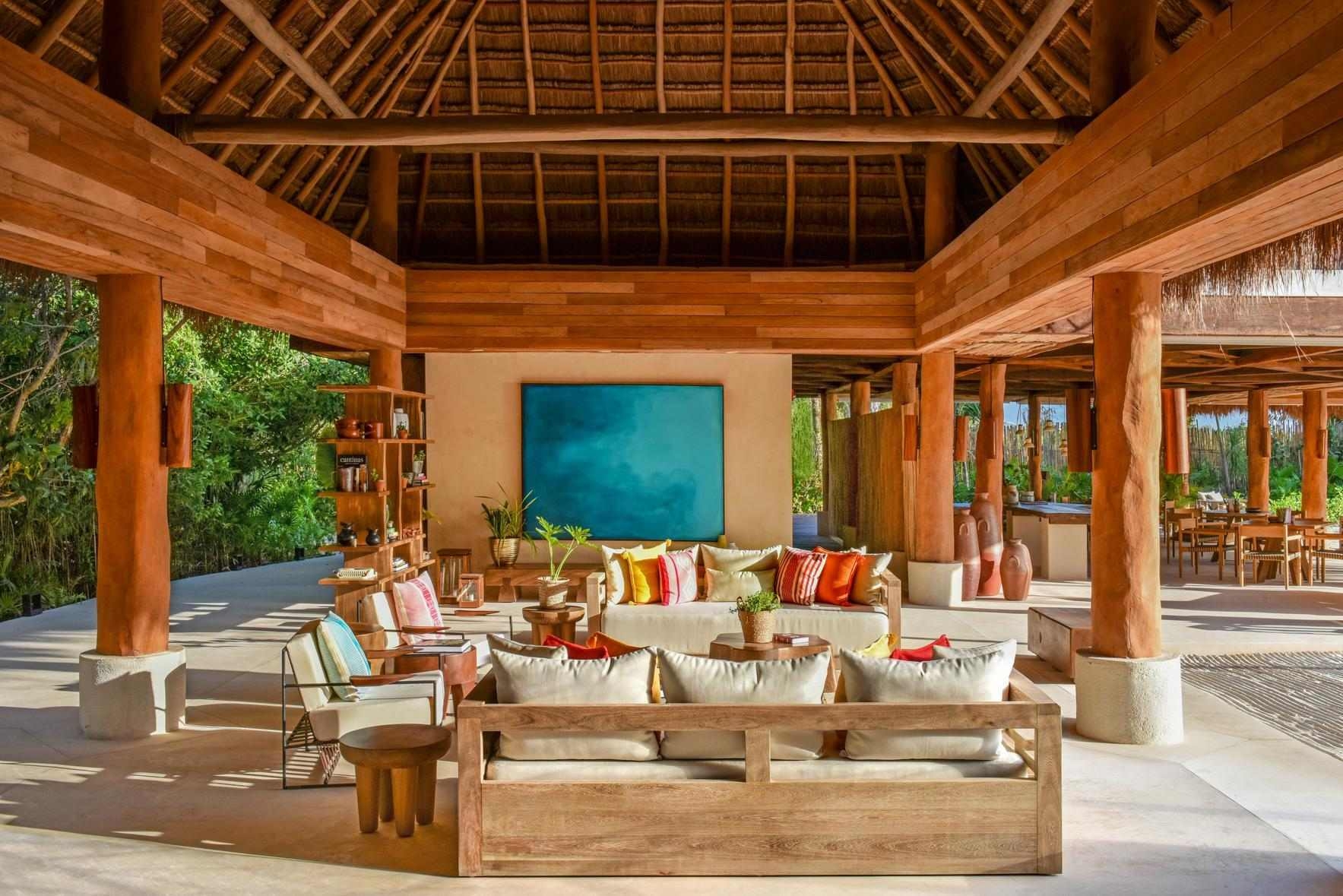A communal lounge area at Rosewood Mayakoba, featuring an airy interior.