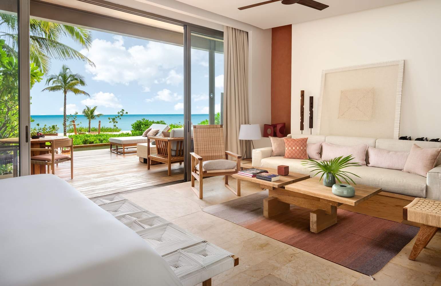 A bedroom of one of Rosewood Mayakoba's beachfront suites, looking out to the Caribbean Sea.