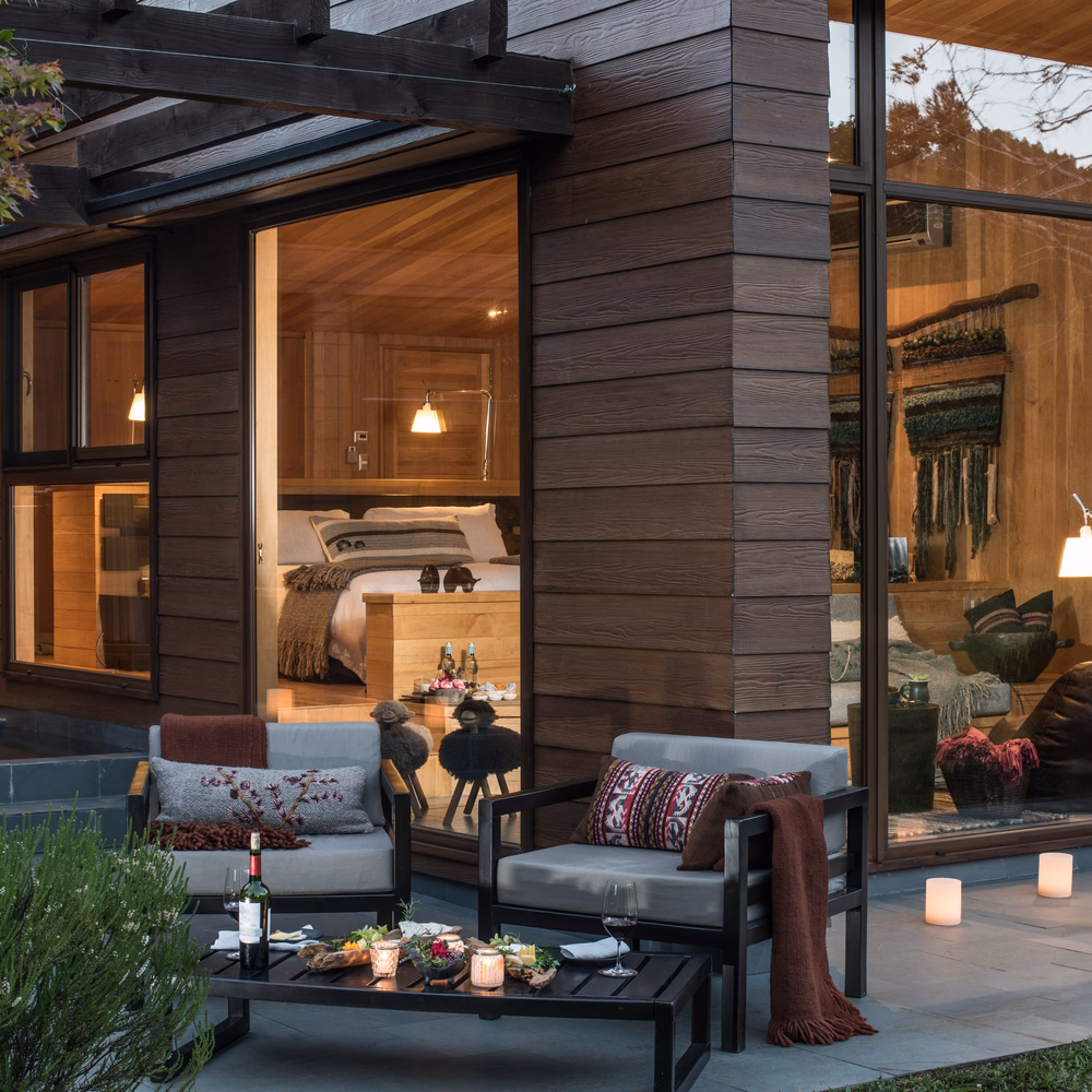 Two chairs on a patio at dusk at &Beyond Vira Vira in Chile
