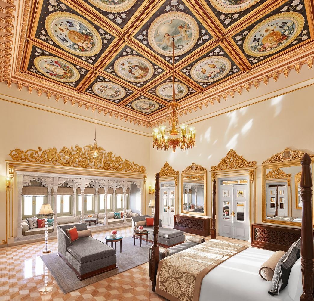 A stately, ornately-styled bedroom at Taj Lake Palace which faces the lake.