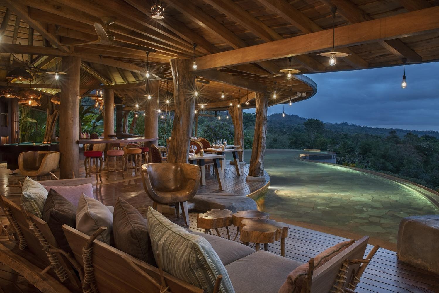 Outdoor terrace at night at Origins Lodge, Costa Rica