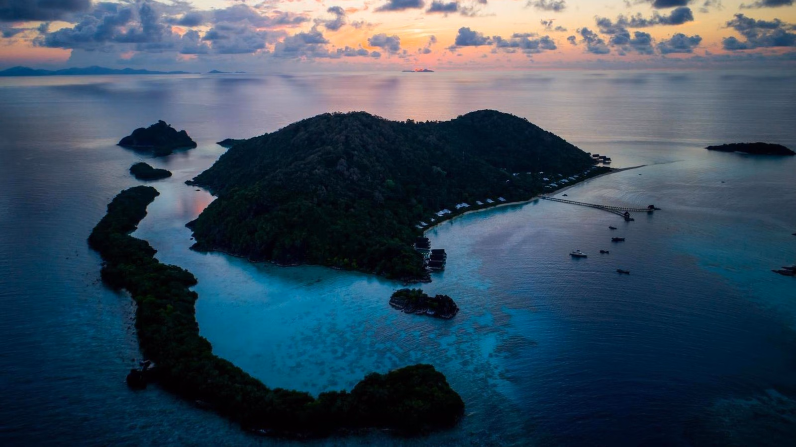 Bawah Reserve is surrounded by a protected 1,000-hectare marine reserve, and land, lush greenery.