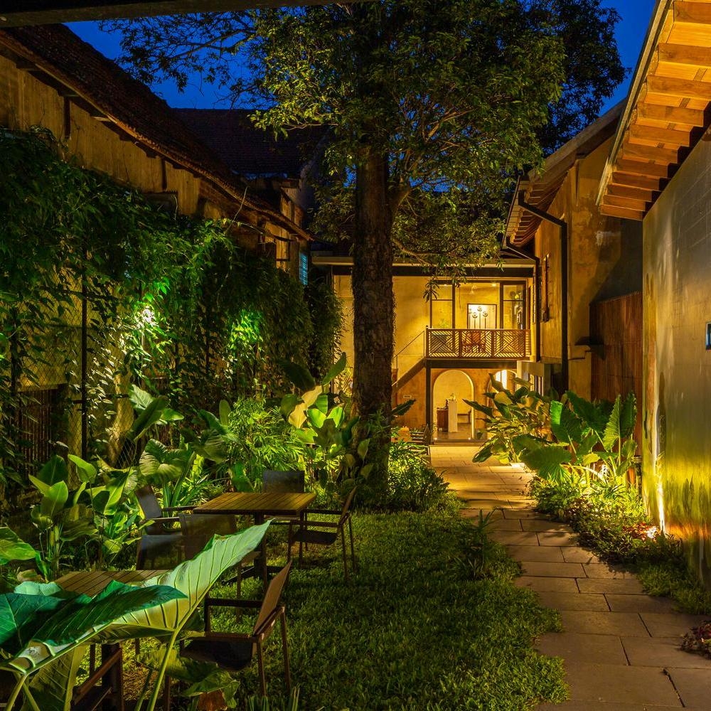 The courtyard lit up at night at The Postcard Mandalay Hall, India