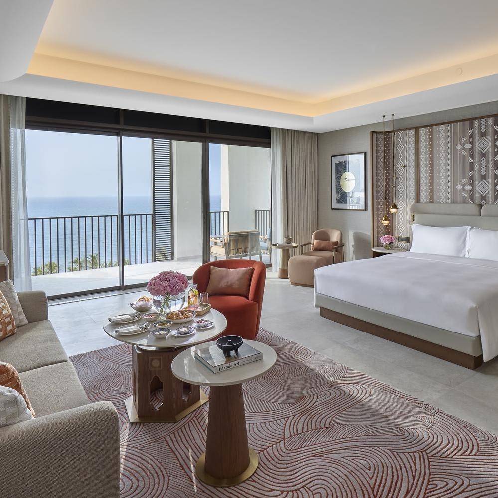 A sea-view suite at Mandarin Oriental Muscat, featuring a terrace overlooking the Gulf of Oman.