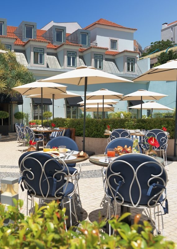 Chairs and tables in the garden at The One Palacio da Anunciada