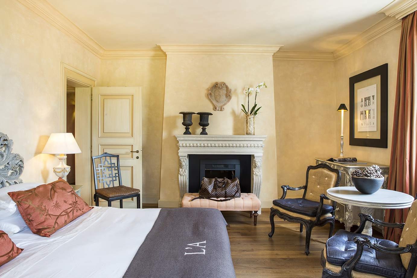 The classic style interior of a room at L’Andana Tenuta La Badiola.