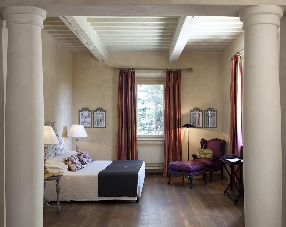 The classic style interior of a suite at L’Andana Tenuta La Badiola.