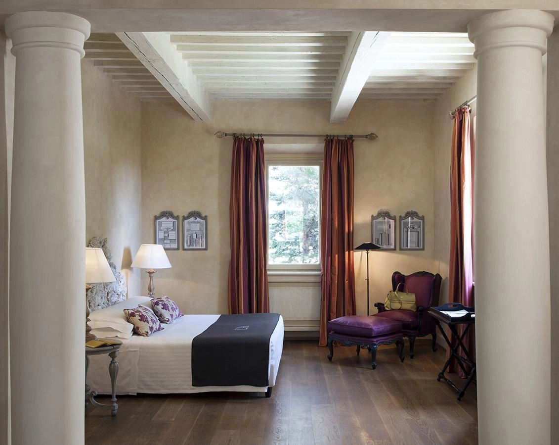 The classic style interior of a suite at L’Andana Tenuta La Badiola.
