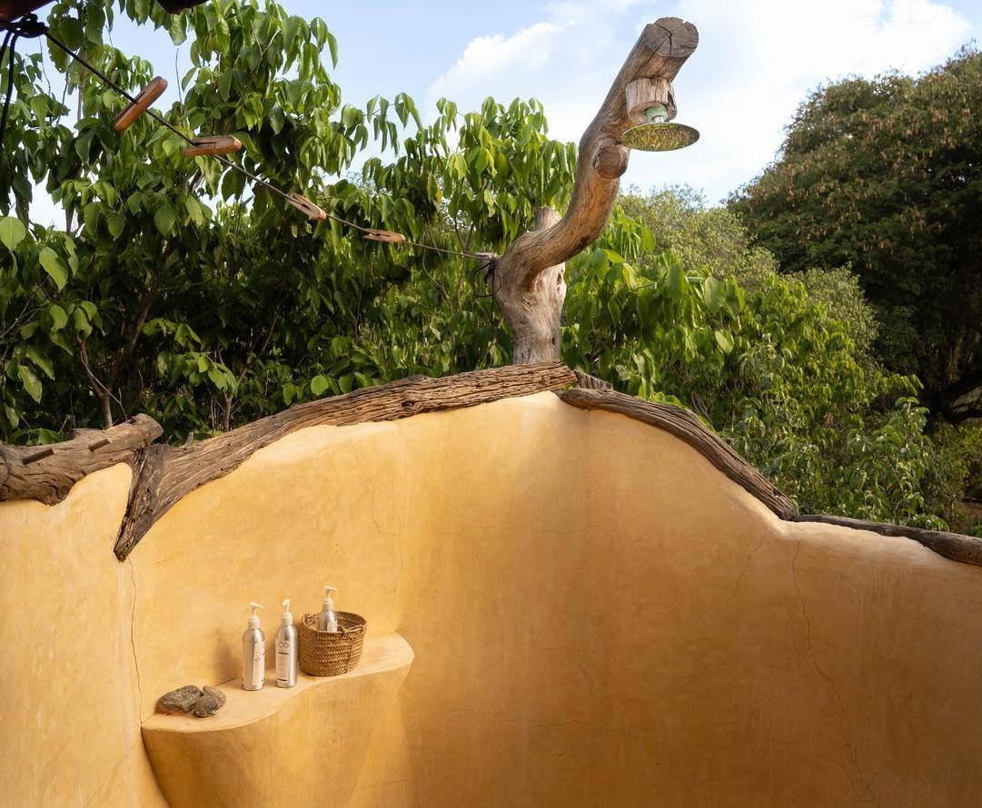 The outdoor shower area of a tent at Sarara Treehouses.